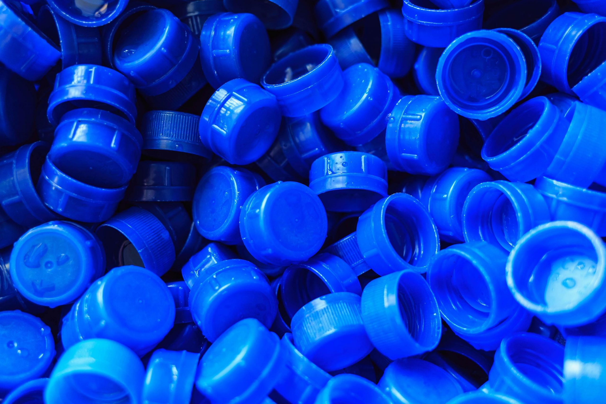 blue-plastic-caps-used-to-seal-beverage-bottles-free-photo
